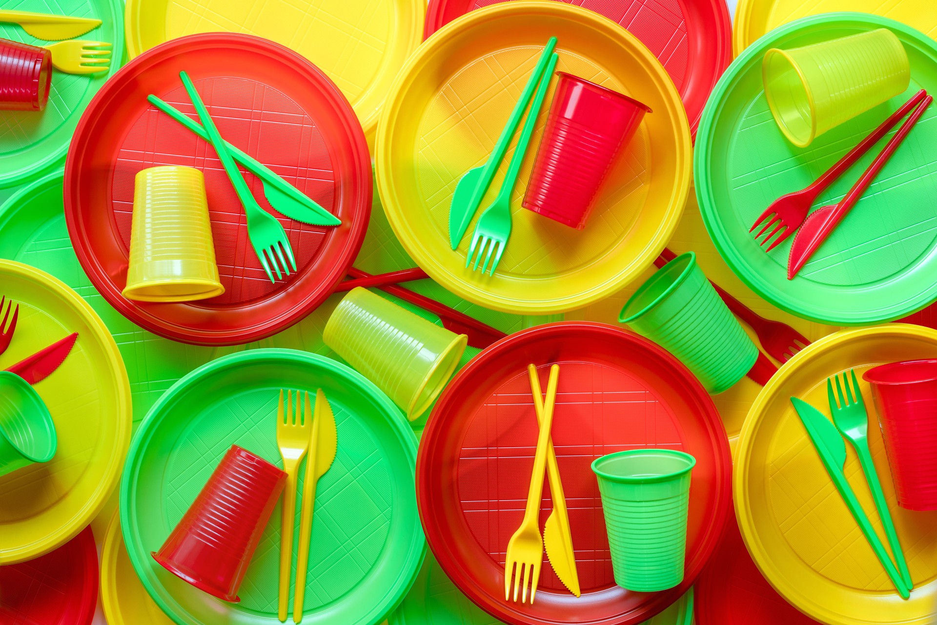 Bright plastic disposable tableware background